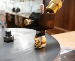 Shows me polishing the table of the Tourmaline on my polishing lap of my faceting machine.